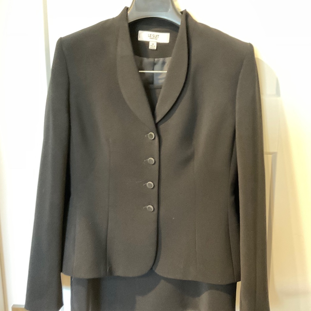 Black rounded collar suit jacket with jet buttons and knee length skirt